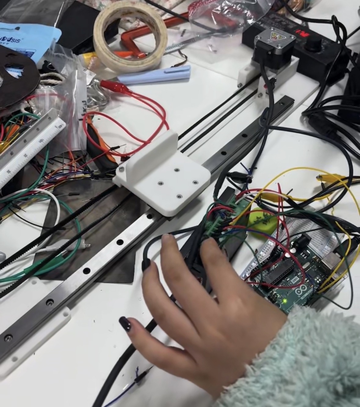 Close-up of students wiring sensors and electronic components for a prototype